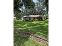 Lovely single-story brick home with manicured front lawn and mature trees at 4106 Old Mulberry Rd, Plant City, FL 33567