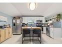 Charming kitchen featuring white cabinets, stainless steel appliances and a kitchen island at 5315 40Th N St, St Petersburg, FL 33714