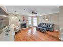 Bright living room features a fireplace, ceiling fan, and beautiful hardwood floors at 1000 W Horatio St # 129, Tampa, FL 33606