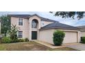 Charming two-story home with well-maintained lawn and manicured garden beds at 1209 Alhambra Crest Dr, Ruskin, FL 33570