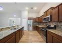 Modern kitchen with granite countertops, stainless steel appliances, and wood flooring at 12117 Streambed Dr, Riverview, FL 33579