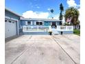 Attractive home with a quaint front porch, a two car garage, and manicured landscaping at 15817 Redington Dr, Redington Beach, FL 33708
