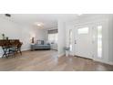 Inviting entryway with wood-look floors, a side window, and ample natural light at 2567 Frisco Dr, Clearwater, FL 33761