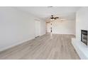 Spacious living room featuring modern flooring and a cozy white brick fireplace at 3568 Wilkinson Woods Dr # 23, Sarasota, FL 34231