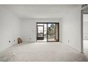 Unstaged living room with sliding glass doors leading to outdoor space and lots of natural light at 358 Moorings Cove Dr # 4B, Tarpon Springs, FL 34689