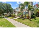 Attractive exterior view of a two-story house with palm trees and lush landscaping at 5955 Caldera Ridge Dr, Lithia, FL 33547