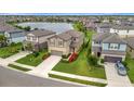 Aerial view of the homes and lake, highlighting the community and landscaping at 6555 Kenava Loop, Palmetto, FL 34221