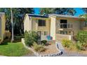 Inviting townhome with a quaint balcony and attractive landscaping, showcasing a welcoming facade at 9027 Pebble Creek Dr, Tampa, FL 33647