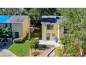 Aerial view of a cozy townhome with well-kept lawn, sidewalk, and green surroundings, highlighting its appeal at 9027 Pebble Creek Dr, Tampa, FL 33647