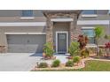 Attractive home features a stone accented entrance with lush landscaping and a three car garage at 9456 Channing Hill Dr, Sun City Center, FL 33573