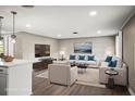 Staged living room featuring neutral tones, plush seating, and a stylish layout for relaxing and entertaining at 1018 Osprey Ct, Dunedin, FL 34698
