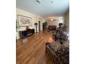 Open living room featuring hardwood floors, neutral walls, and modern furniture at 11439 Cambray Creek Loop, Riverview, FL 33579