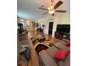 Spacious living room featuring hardwood floors, neutral walls, and stylish furnishings at 11439 Cambray Creek Loop, Riverview, FL 33579