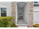 Welcoming entryway with a stone archway and tiled floor at 12928 Twin Bridges Dr, Riverview, FL 33579