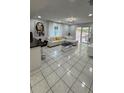 Bright living room featuring tile floors, open layout to the kitchen, and stylish contemporary furniture at 1900 W Kirby St, Tampa, FL 33604