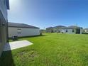 Home featuring a spacious backyard with lawn and privacy from neighboring properties at 35233 White Water Lily Way, Zephyrhills, FL 33541
