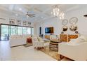 Spacious living room featuring stylish decor, a coffered ceiling, and large windows that offer natural light at 4372 Night Star Trl, Odessa, FL 33556