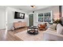 Cozy living room with wood floors, a comfortable sofa, decorative accents, and plenty of natural light at 500 62Nd S St, St Petersburg, FL 33707
