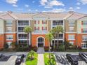 Aerial view of modern condo building with private balconies and well-manicured landscaping, showcasing property at 7903 Seminole Blvd # 2203, Seminole, FL 33772