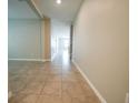 Bright hallway featuring ceramic tile flooring and neutral wall colors at 9650 Sage Creek Dr, Ruskin, FL 33573