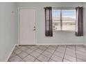 Bright room featuring tile flooring, neutral walls, a large window, and an entry door at 1049 Apollo Beach Blvd # D, Apollo Beach, FL 33572