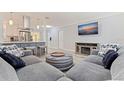 Comfortable living room featuring a large sofa, decorative ottoman, and an entertainment center at 11451 82Nd Ave, Seminole, FL 33772