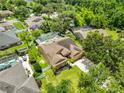 Aerial view of home showing screen enclosed pool, well-manicured lawn and fenced yard at 12305 Freesia Ct, Riverview, FL 33569