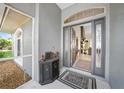 Inviting foyer with a welcome mat, decorative cabinet, and view into the open-concept living spaces at 2226 Charleston Park Dr, North Port, FL 34287