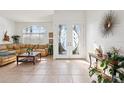 Bright foyer with tiled floors, glass front doors, and ample natural light from the large windows at 23346 Abercorn Ln, Land O Lakes, FL 34639