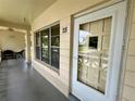 Inviting condo entrance with a well-lit porch, large windows, and a glass-paneled door showcasing curb appeal at 2400 Franciscan Dr # 28, Clearwater, FL 33763