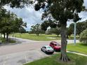 Convenient parking lot view featuring a golf course and mature trees, providing a scenic backdrop at 2400 Franciscan Dr # 28, Clearwater, FL 33763