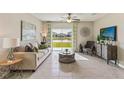Bright living room with pond view and stylish furnishings at 2621 Birney Run, Zephyrhills, FL 33541