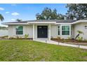 Close-up of the front entrance highlighting the double front doors and freshly landscaped garden beds at 7108 14Th Nw Ave, Bradenton, FL 34209