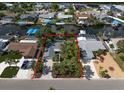 Aerial view of a single-story home on a waterfront property with mature trees at 911 Sago Palm Way Way, Apollo Beach, FL 33572