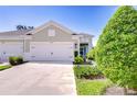 Charming single-story home featuring a two-car garage, landscaping, and a welcoming front porch at 13621 Circa Crossing Dr, Lithia, FL 33547