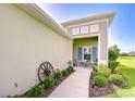 Welcoming front porch with comfortable seating and charming decor, framed by lush landscaping at 13621 Circa Crossing Dr, Lithia, FL 33547