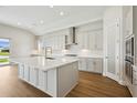 Bright kitchen featuring white cabinets, stainless steel appliances, and a large island at 15003 Rider Pass Dr, Lithia, FL 33547