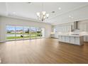 Spacious living room adjoins kitchen and features scenic backyard water views from sliding glass doors at 15003 Rider Pass Dr, Lithia, FL 33547