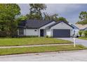 Single-story home featuring a well-maintained lawn, and a two-car garage, with brick and siding at 2908 Longbrooke Way, Clearwater, FL 33760