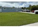 Single story house with well kept lawn, and concrete driveway at 2927 W Henry Ave, Tampa, FL 33614