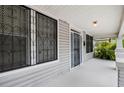 Inviting front porch with white columns and railing, featuring a view of the surrounding landscape at 3105 N 16Th St, Tampa, FL 33605