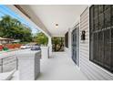 Charming front porch with white columns and railing, offering a relaxing outdoor space at 3105 N 16Th St, Tampa, FL 33605