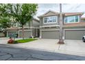 Well-maintained townhome exterior featuring an attached garage and tidy landscaping at 3298 Covered Bridge W Dr, Dunedin, FL 34698
