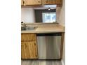 Kitchen featuring stainless steel dishwasher, laminate countertop and wood cabinets at 3610 54Th W St # B8, Bradenton, FL 34209