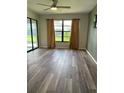Bright living room with stylish gray flooring, neutral walls, and large windows at 3610 54Th W St # B8, Bradenton, FL 34209