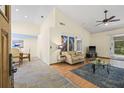 Spacious living room with tile and wood floors, ceiling fan and lots of light at 3810 Darston St, Palm Harbor, FL 34685