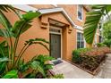 Charming home exterior with a welcoming front door, lush greenery, and manicured landscaping at 7001 Interbay Blvd # 121, Tampa, FL 33616