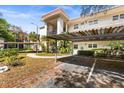 Exterior view of condos featuring carports and walkway at 840 Virginia St # 301, Dunedin, FL 34698