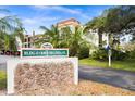 Community signage displaying the building number and street address in front of condo building at 840 Virginia St # 301, Dunedin, FL 34698