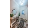 Inviting foyer with decorative rug, tiled floor, coat rack, console table with decor, and front door with glass panel at 878 Franklin Cir, Palm Harbor, FL 34683